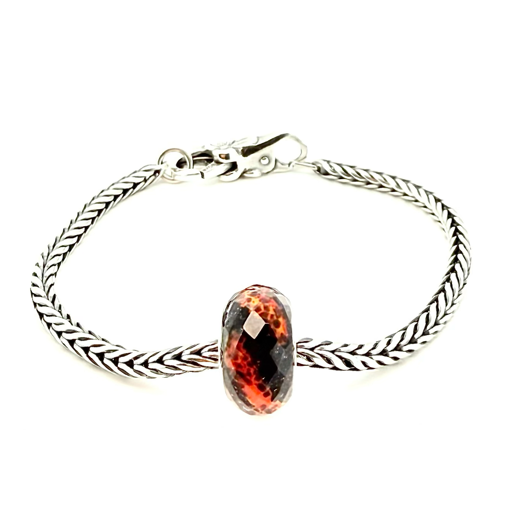 Volcanic Eruption Bead - by Trollbeads is designed by Bolli Ófeigsson goldsmith. Born from Fire - Inspired by Iceland’s volcanic power, this bead captures the beauty of flowing lava – a reminder of the island’s untamed energy and natural wonder. Available exclusively in Iceland. Ófeigur gullsmiðja, Skólavörðustíg 5. ofeigur.is