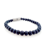 A beaded stretch bracelet made of dark gray porous lava stone beads, featuring a titan cylindrical magnetic clasp engraved with "Iceland" and the Raidho rune,ancient Norse symbol of safe travels.