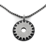 Solar Power is a bold titanium pendant by Zeezen, designed by Bolli Ófeigsson. Its oxidized finish and rugged surface give it a raw, distinctive character.