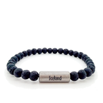 A beaded stretch bracelet made of dark gray porous lava stone beads, featuring a titan cylindrical magnetic clasp engraved with "Iceland" and the Raidho rune,ancient Norse symbol of safe travels.