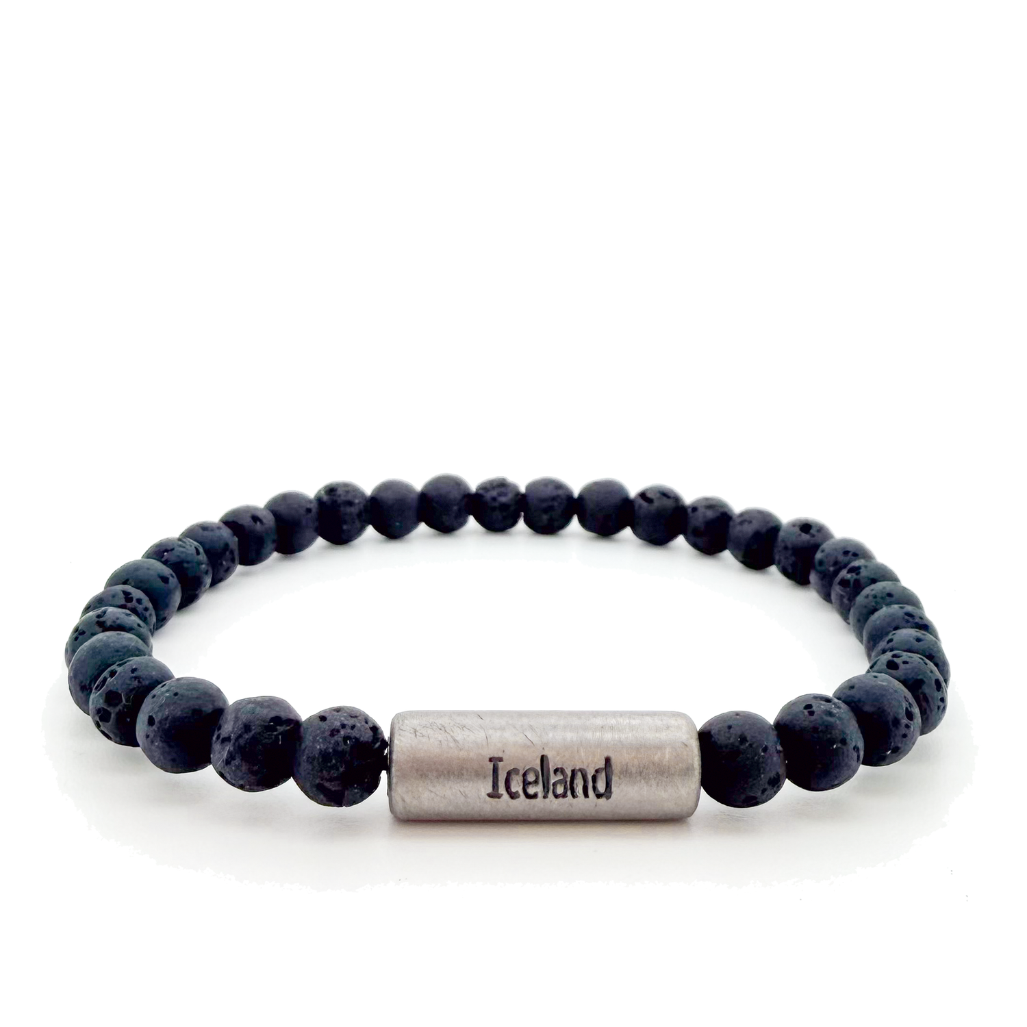A beaded stretch bracelet made of dark gray porous lava stone beads, featuring a titan cylindrical magnetic clasp engraved with "Iceland" and the Raidho rune,ancient Norse symbol of safe travels.