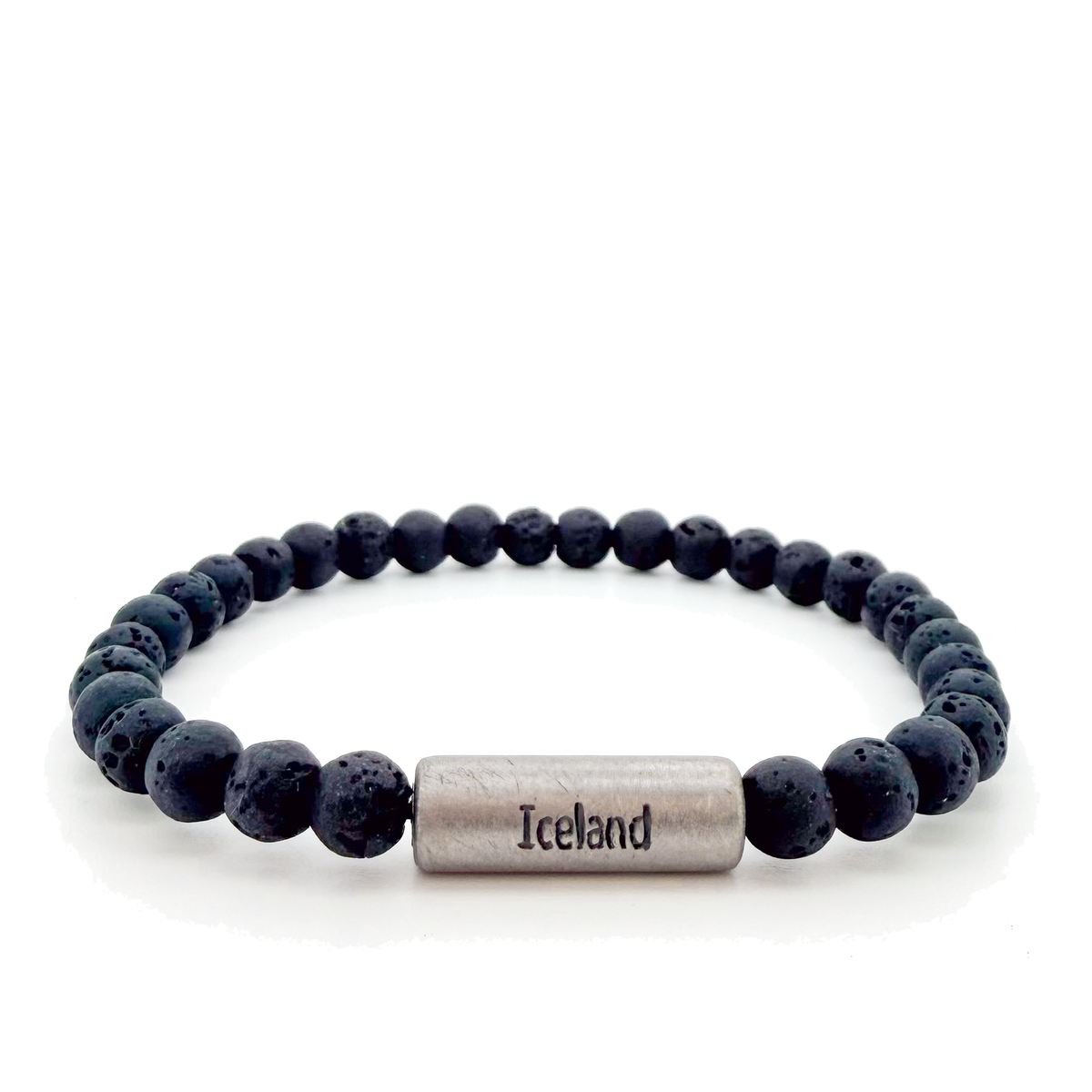 A beaded stretch bracelet made of dark gray porous lava stone beads, featuring a titan cylindrical magnetic clasp engraved with "Iceland" and the Raidho rune,ancient Norse symbol of safe travels.